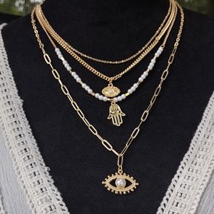 Multi layer evil eye and pearl necklace.